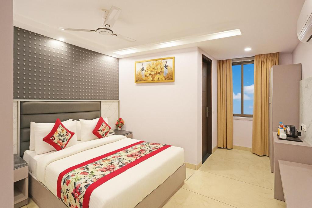 a bedroom with a large bed and a bathroom at Hotel Mayfair Just a Minute Away From New Delhi Railway Station and Connaught place in New Delhi