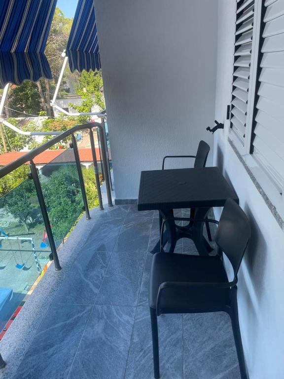 a table and chairs sitting on a balcony with a view at Residenza Seliano in Velipojë