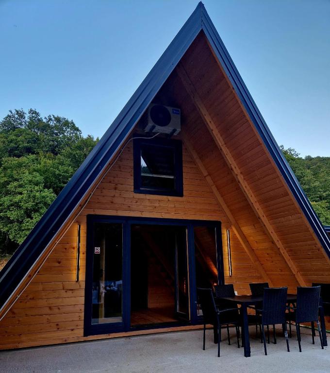 a house with a table and chairs in front of it at Fikro's Resort in Kulen Vakuf