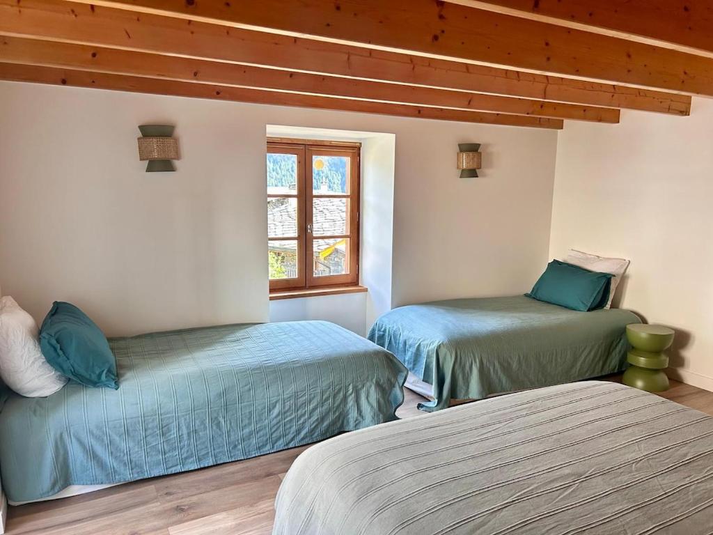 a bedroom with two beds and a window at Maison Lajouanie, 10 pers, Orelle, Val Thorens, bike in Saint-André