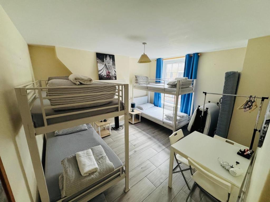 a small room with bunk beds and a desk at APlaceToStay Central London apartment, Zone 1 LEIC in London