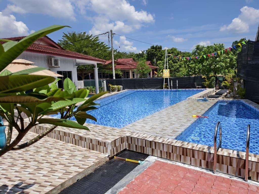a swimming pool in a villa with a house at Family Villa - BERA Poolstay 