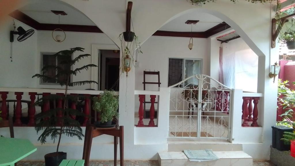 a house with an arched entryway with a plant at Casa De Emilia in Anjuna