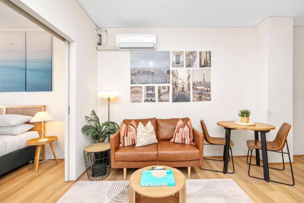 a living room with a couch and a table at Perth City Retreat Victoria Ave 1br in Perth