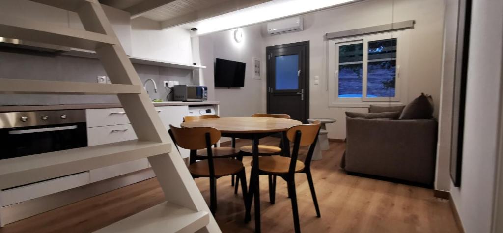 a kitchen and dining room with a table and chairs at Mairyren Luxury apartment in Ano Syros