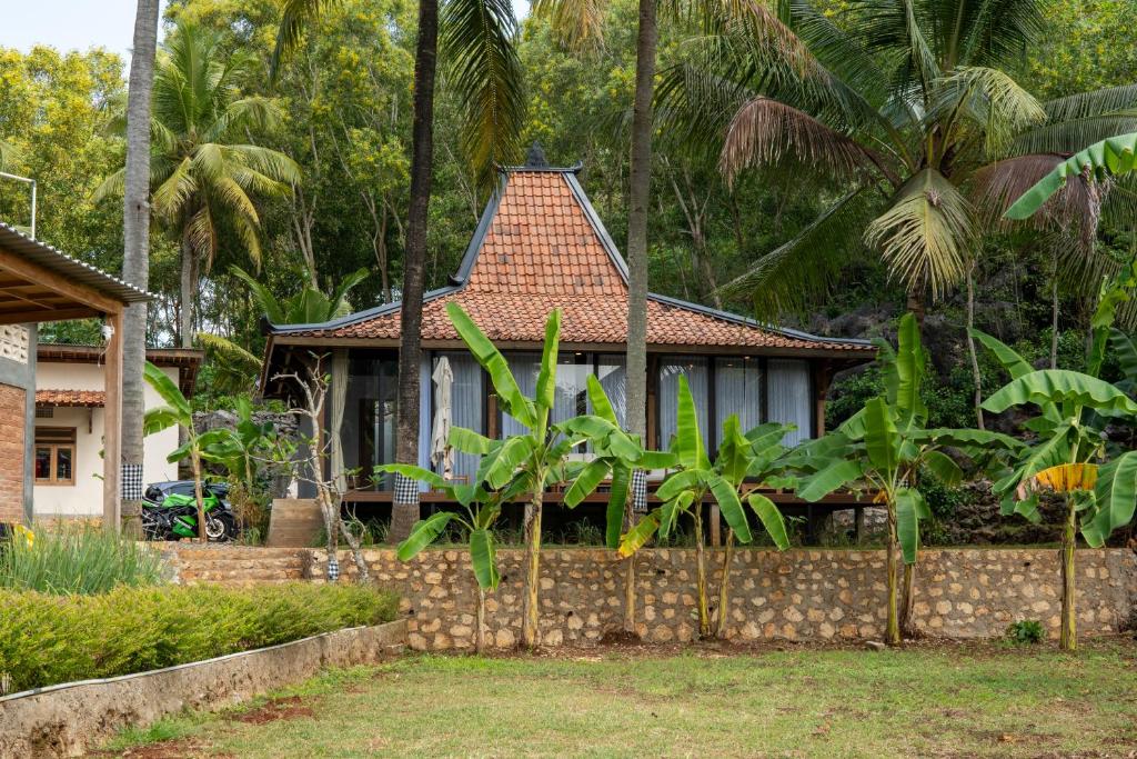 a house with a fence in front of it at Terra Clementia in Watukarung
