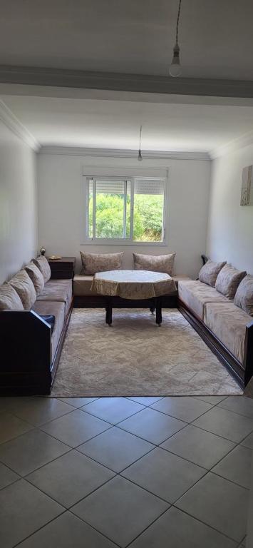 a living room with two couches and a coffee table at Forest & Ocean Appart 13 in Tangier