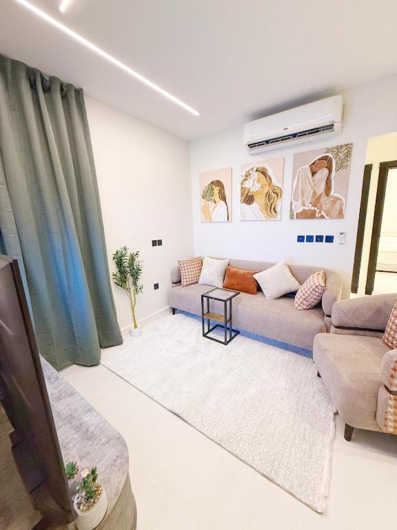 a living room with a couch and a table at 2 Bedrooms Apartment-22B in Riyadh
