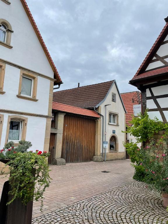 a house with a driveway and a garage at Weingut und Destillerie Bernd Klein in Pleisweiler-Oberhofen