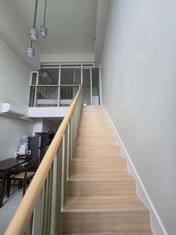 a staircase in a room with wooden flooring at Mandani Bay Suites Tower 2 - Cebu City in Mandaue City