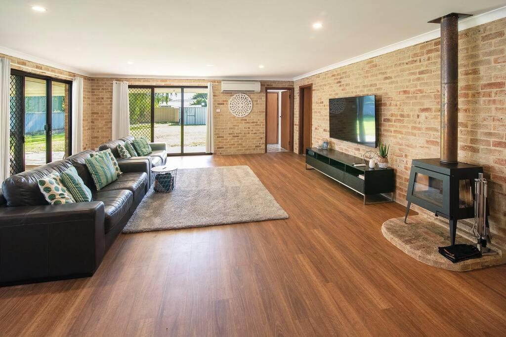 a living room with a couch and a fireplace at Duke Street Hideaway in Busselton