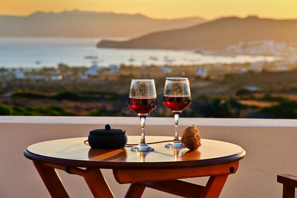 two glasses of red wine sitting on a table at Villa Almar in Adamas