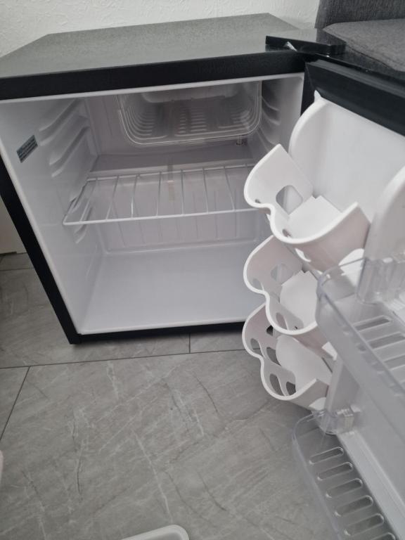 an empty refrigerator with its door open with its door open at Einliegerwohnung mit 2 Zimmern, Badezimmer, küche in Waldshut-Tiengen