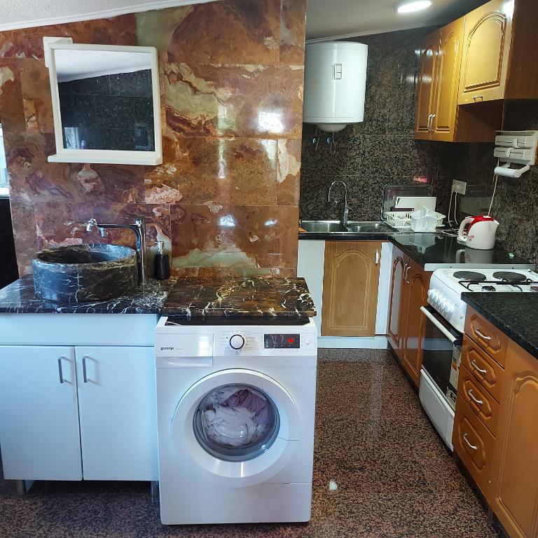 a kitchen with a washing machine and a sink at Studio Relax in Travnik