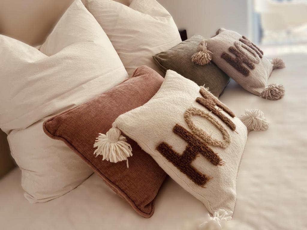 a pile of pillows sitting on a bed at Studio Fifty9 in Knokke-Heist