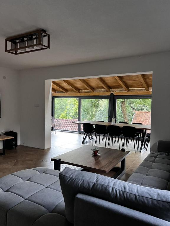 a living room with a couch and a table at Vikendica Radoš in Tutnjevac