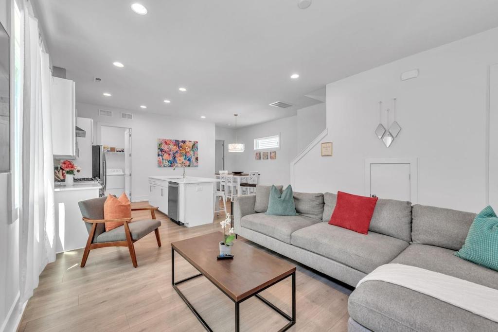 a living room with a couch and a table at 4BR Queen City Base Minutes to Stadium & NoDa in Charlotte