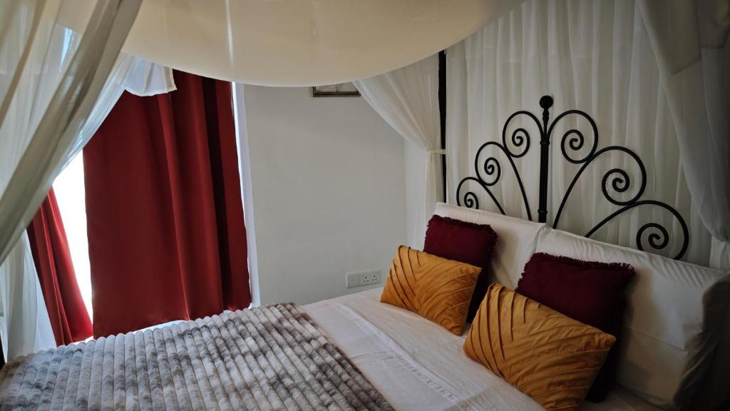 a bedroom with a bed with colorful pillows at Kozakos Luxury House in Pano Lefkara