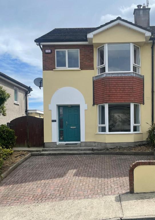 a house with a green door on a brick driveway at 19 college Green in Wexford