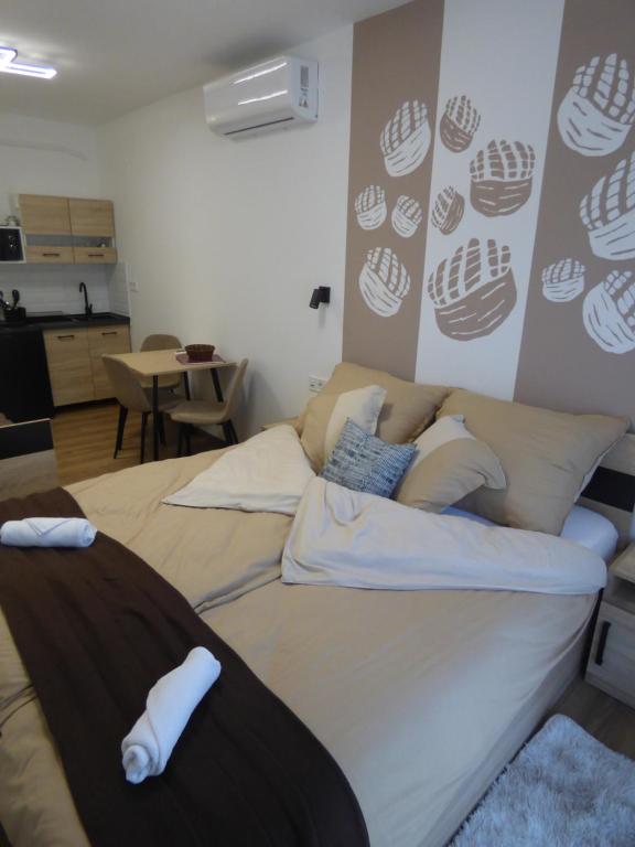 a living room with a couch with pillows on it at Pogácsás II Apartman Tokaj in Tokaj
