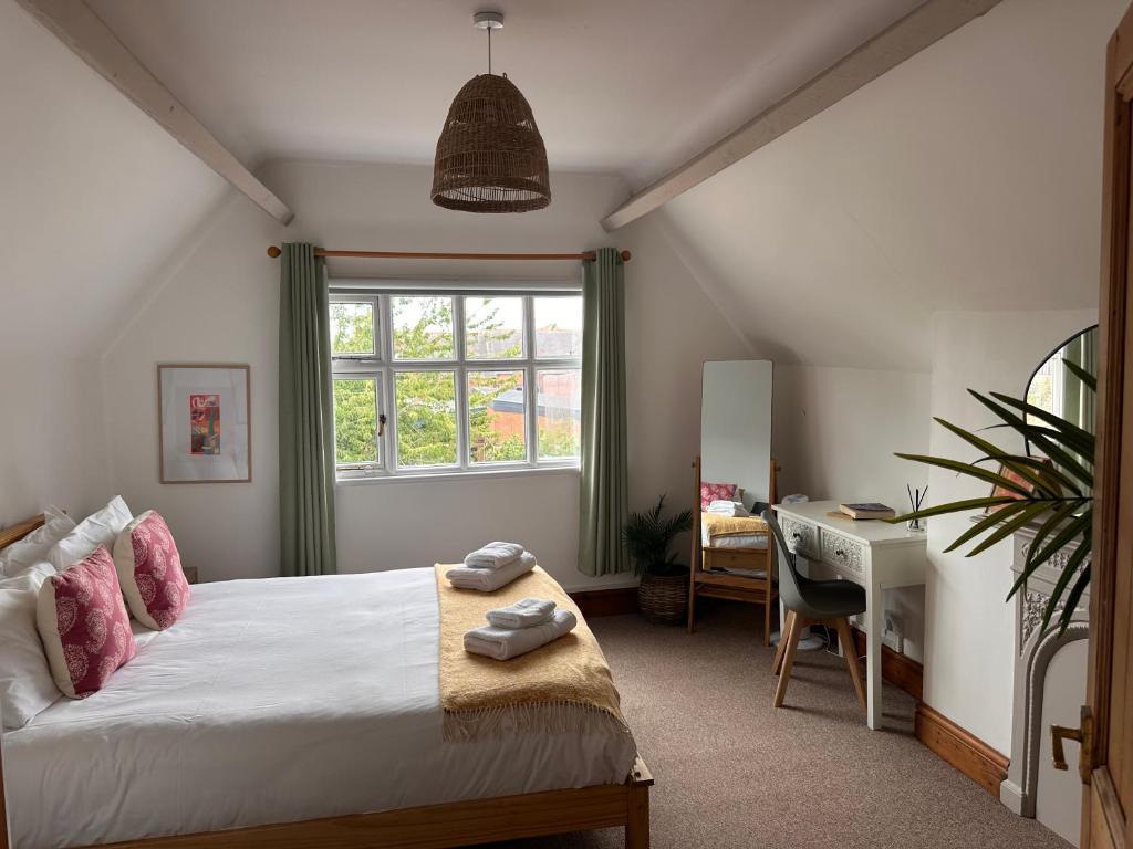a bedroom with a bed and a desk and a window at Chester City Centre Apartments in Chester