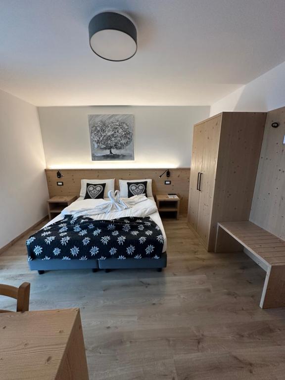 a bedroom with a bed with a blue comforter at LE 4 STAGIONI in Cavedago