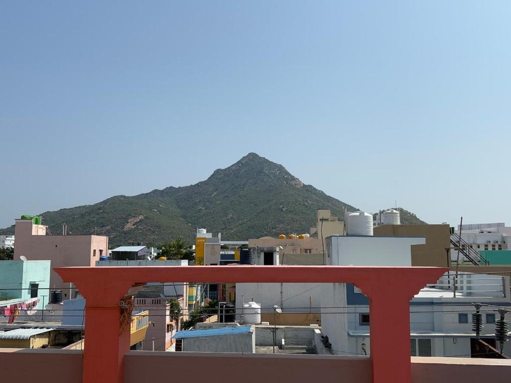 a red bench sitting on top of a city at Entire 2BHK and a garden parking in Tiruvannāmalai