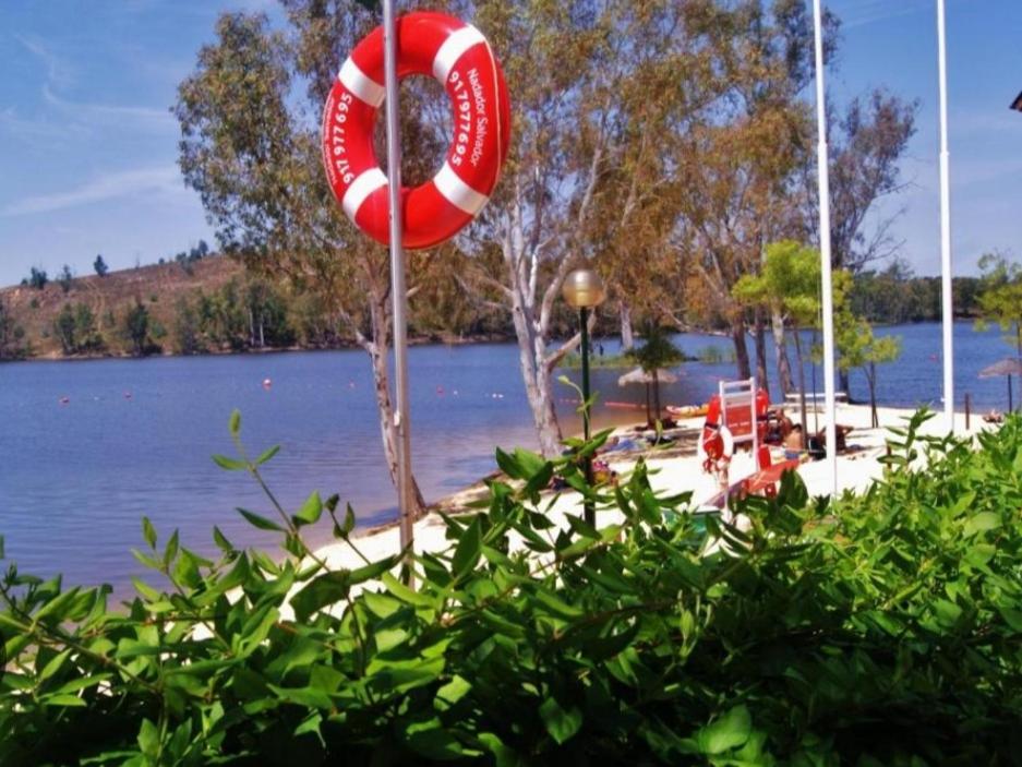 a life preserver on a pole next to a body of water at Casa da Corte in Mina de São Domingos
