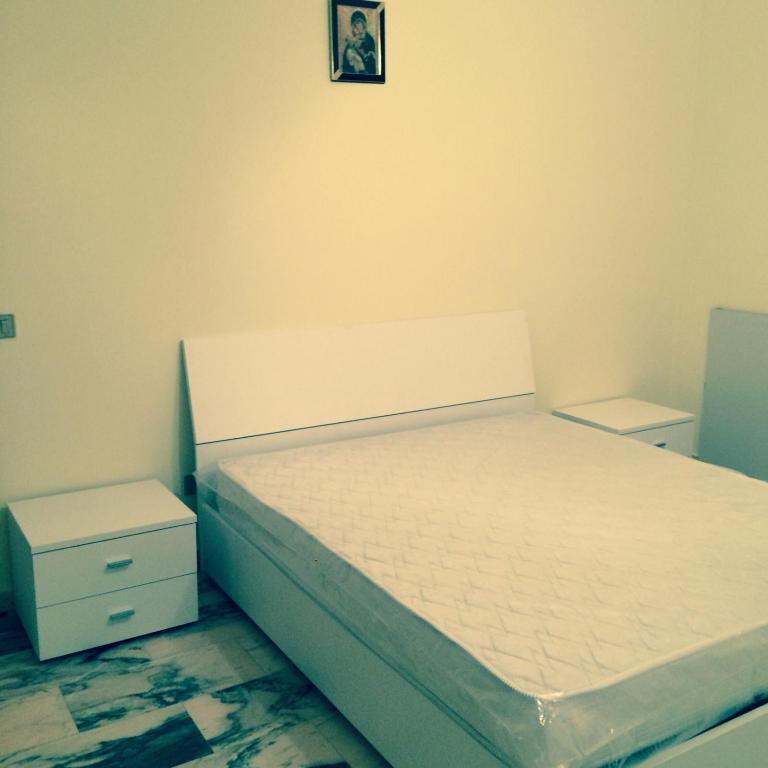 a bedroom with a bed and two night stands at Casa Spadpan in Spadafora