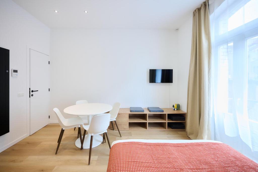 a bedroom with a table and chairs and a bed at Apartment Forest Center 2 in Brussels