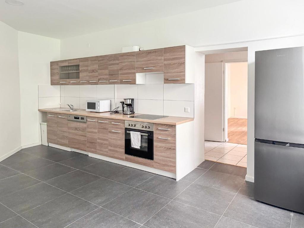 a kitchen with a stove and a refrigerator at 6 room detached house - Köln Messe Fair 10min in Cologne