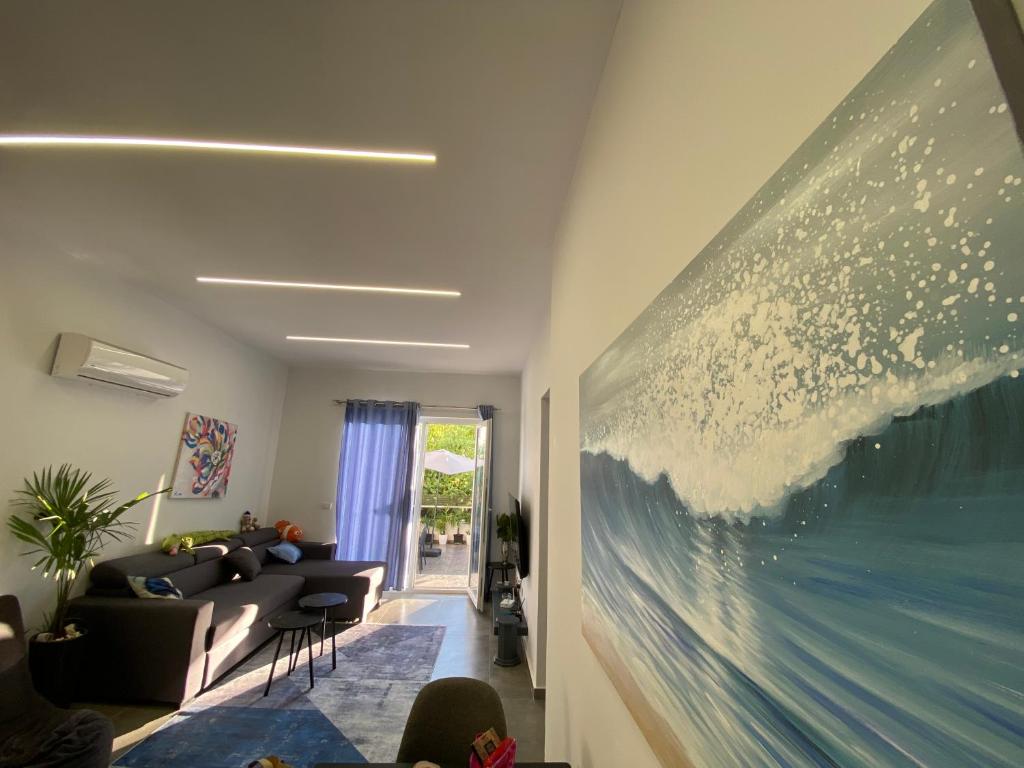 a living room with a large painting on the wall at Premium Apartament , Golem in Golem