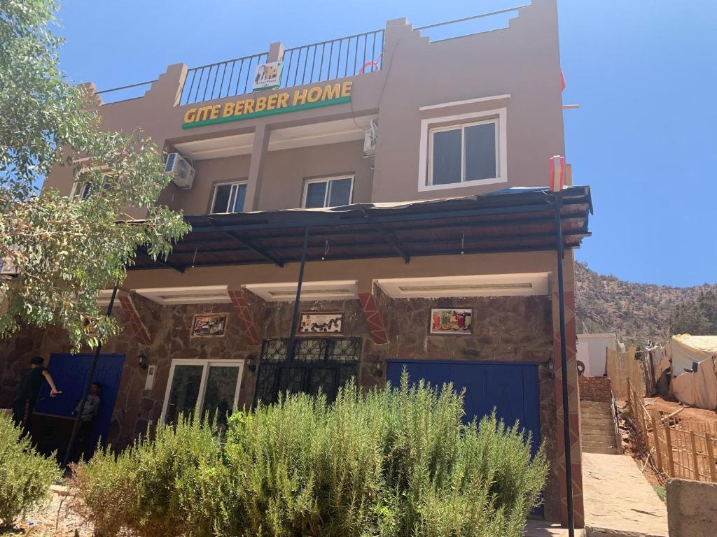 a building with a sign that reads one ginger house at Gite Berber home in Azal