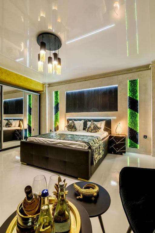 a bedroom with a king sized bed and a table at Rasarit la Mare Premium in Constanţa