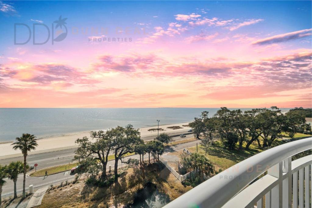 a balcony with a view of a beach and the ocean at Legacy Tower II 608 Deluxe in Gulfport