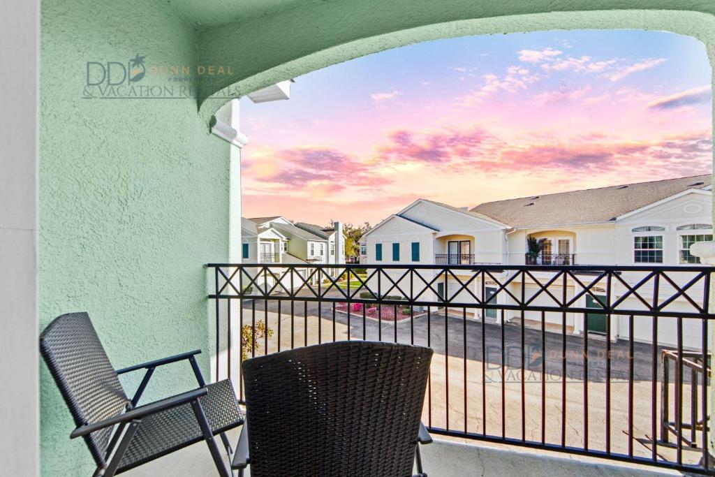 a balcony with two chairs and a view of the beach at Legacy Villa 1504 in Gulfport