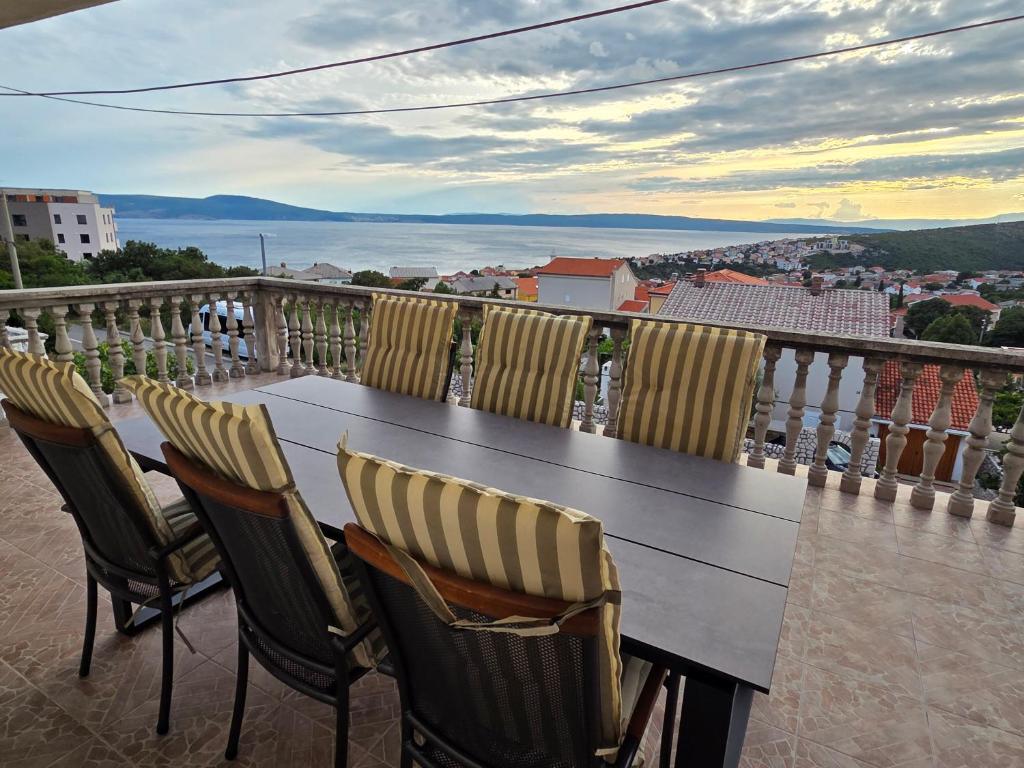 a table and chairs on a balcony with a view at Mateo in Novi Vinodolski
