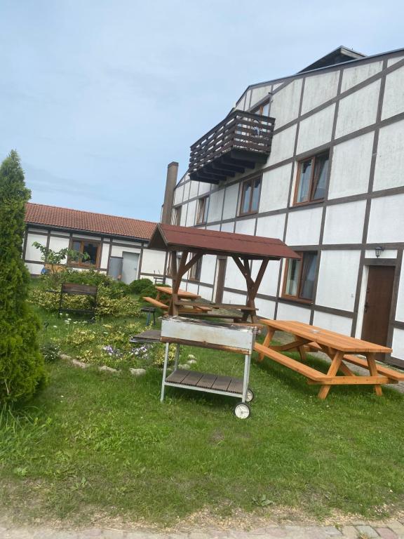 a picnic table and bench in front of a building at Rozalia in Stary Borek
