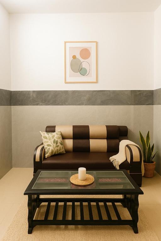 a living room with a couch and a coffee table at Radha Rachna Apartment in Vrindāvan