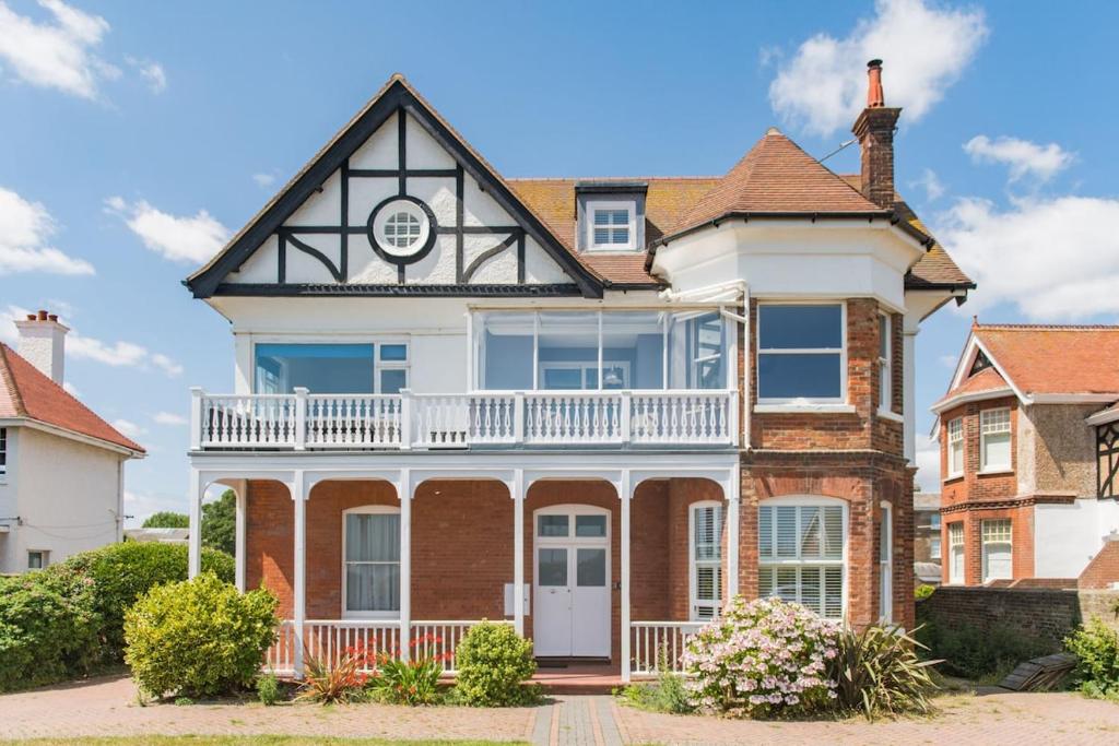 a large red brick house with a white turret at Holmwood by Keepers Cottages in Walmer