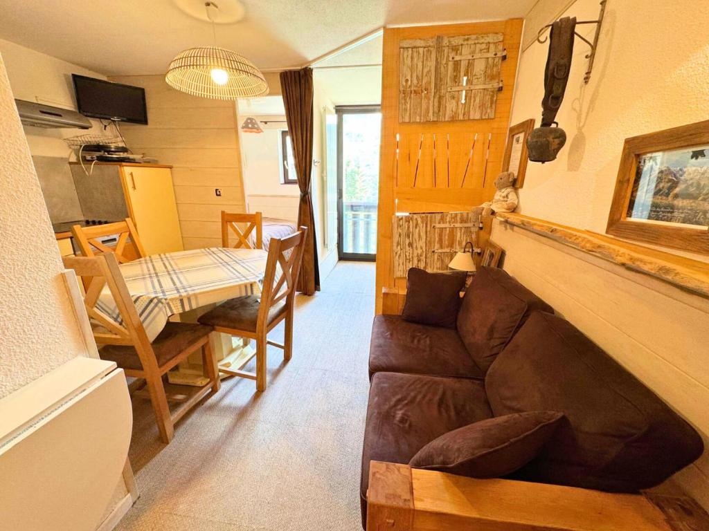 un salon avec un canapé et une table dans l'établissement Résidence Ski Soleil - Magnifique studio déco style chalet au pied des pistes MAE-5704, aux Menuires