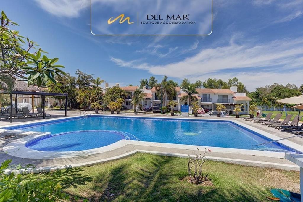 a swimming pool at a villa with a resort at Lomas del Sol in Jarretadera