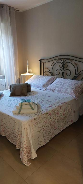 a bedroom with a large bed with a white bedspread at Linda's Holiday Home in Roccastrada