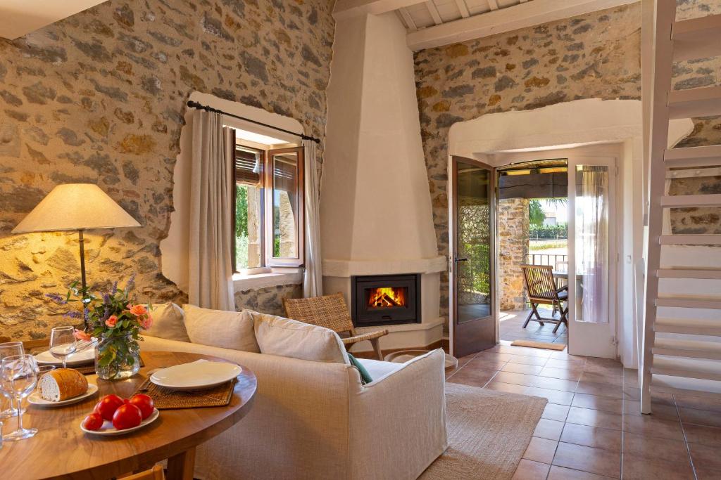 een woonkamer met een bank en een open haard bij Mas Vermell in Fontanilles