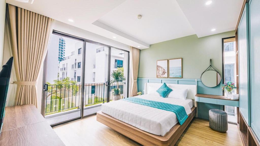 a bedroom with a bed and a large window at Moonlight Villa Vlasta Sam Son in Thanh Hóa