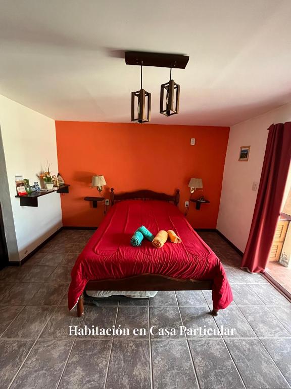 a red bed with a stuffed animal laying on it at Refugio del Alma in San Rafael