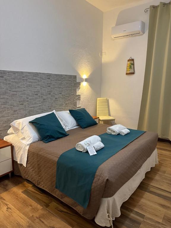 a bedroom with a large bed with towels on it at La Mimosa in Pula