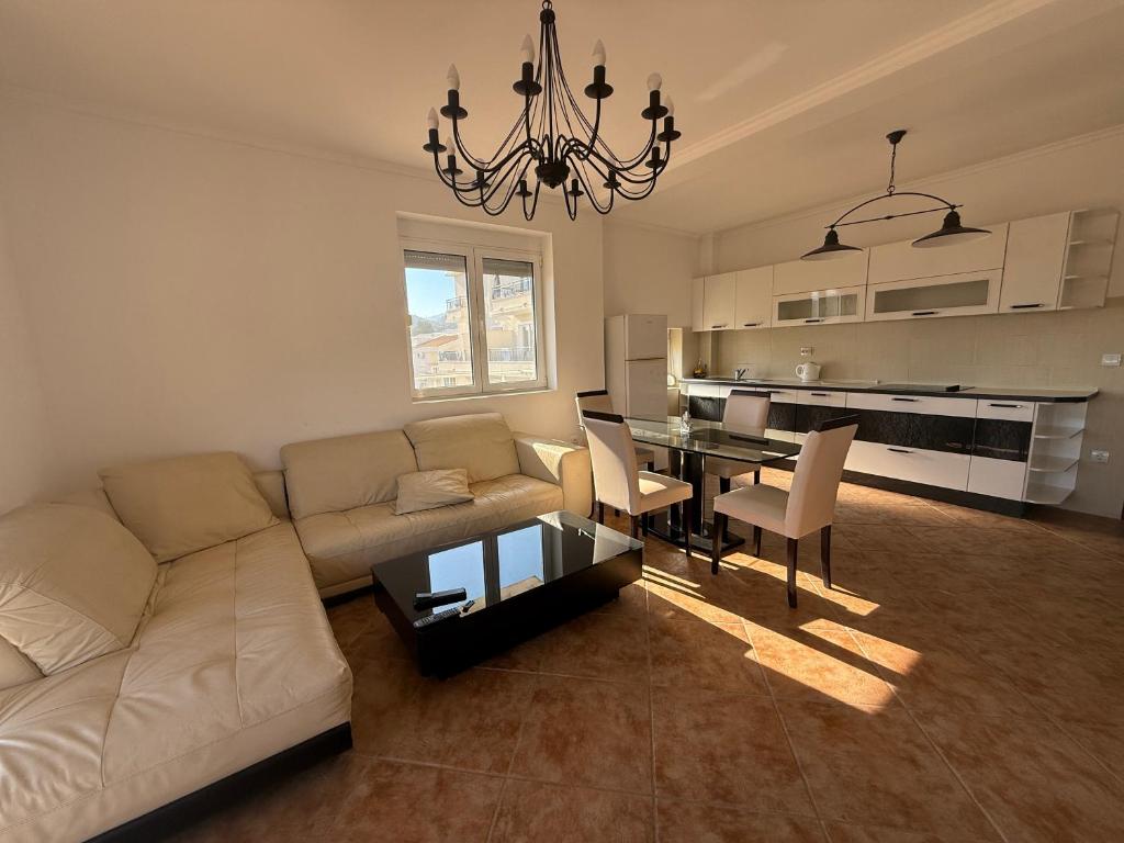 a living room with a couch and a dining table at Simple Stay in Buljarica