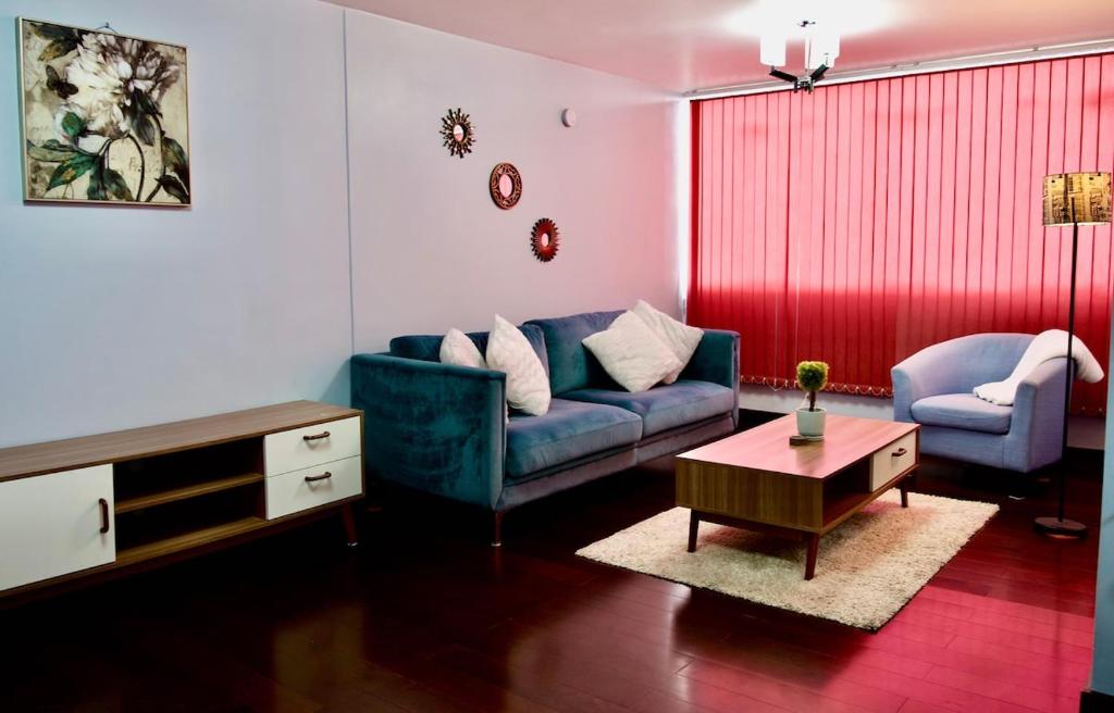 a living room with a blue couch and a table at Cozy & Modern apartment in Arequipa!! in Arequipa
