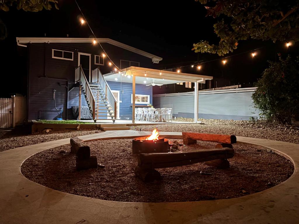a fire pit in a yard at night with lights at Cooee Bay Beach House in Yeppoon